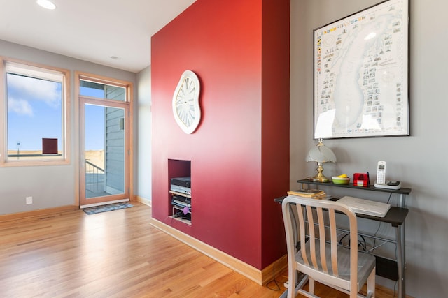 interior space with baseboards and wood finished floors