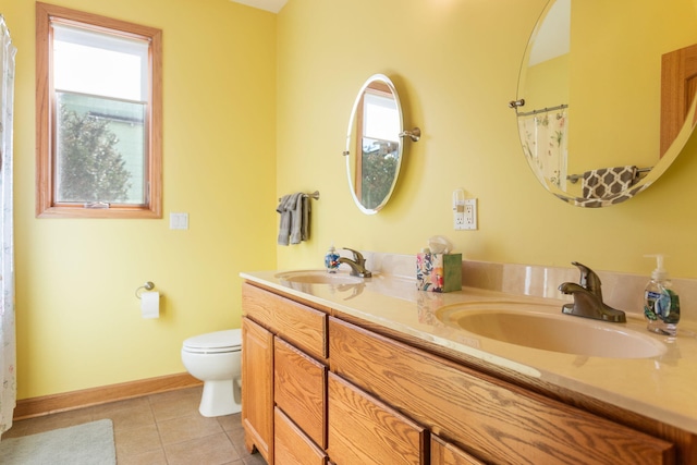 full bathroom featuring tile patterned flooring, toilet, baseboards, and a sink