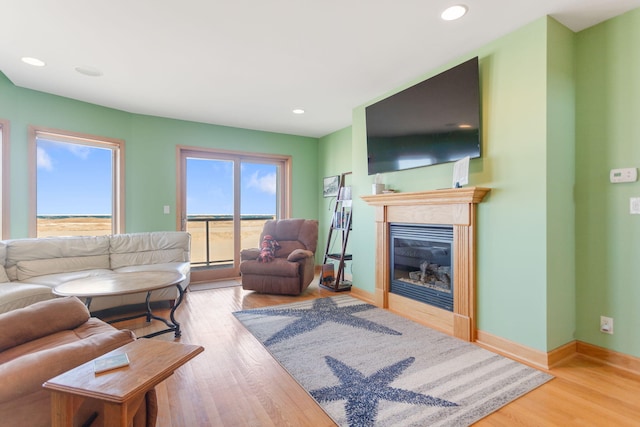 living room featuring recessed lighting, wood finished floors, and baseboards