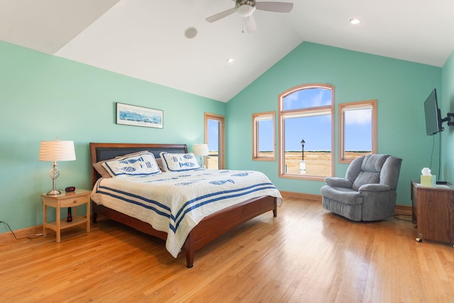 bedroom featuring lofted ceiling, light wood-style flooring, baseboards, and ceiling fan