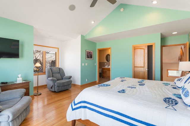 bedroom with baseboards, ensuite bathroom, wood finished floors, high vaulted ceiling, and a ceiling fan