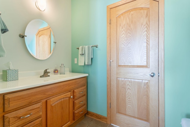 bathroom featuring vanity, tile patterned floors, and baseboards