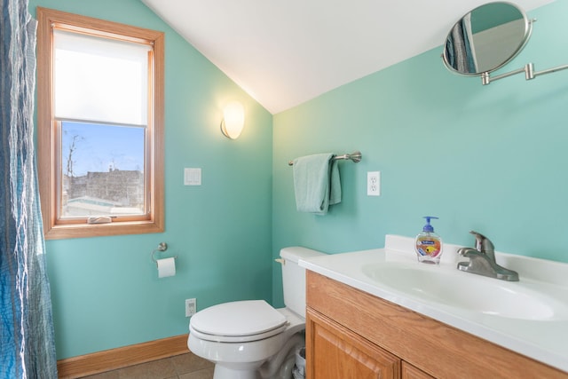 bathroom with vanity, baseboards, lofted ceiling, tile patterned floors, and toilet