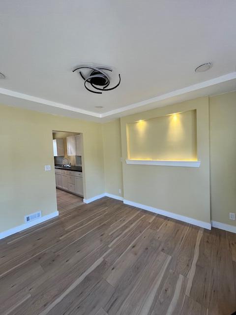 unfurnished room with visible vents, baseboards, and light wood-type flooring