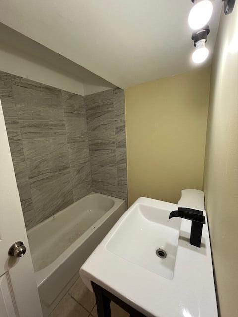 full bath featuring tile patterned flooring and a sink