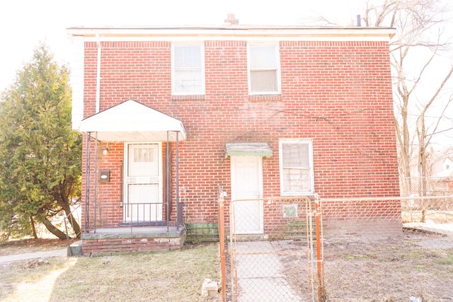 view of front of property featuring fence and brick siding