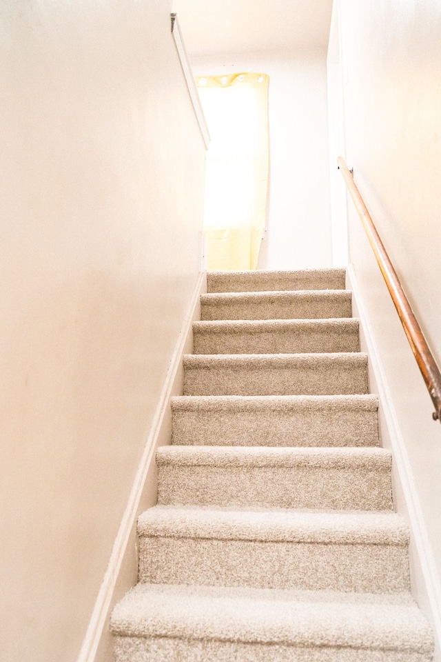 stairway featuring baseboards