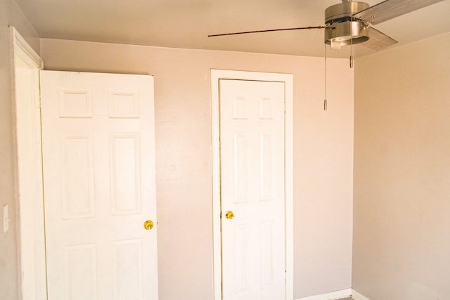 unfurnished bedroom with baseboards and ceiling fan