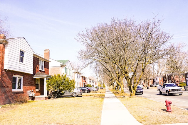 view of road featuring sidewalks, a residential view, and curbs