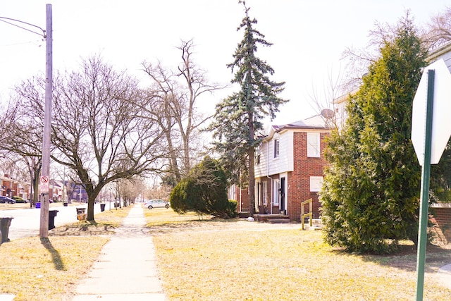 view of street with traffic signs, sidewalks, and a residential view