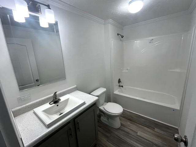 full bath featuring vanity, wood finished floors, bathtub / shower combination, crown molding, and toilet