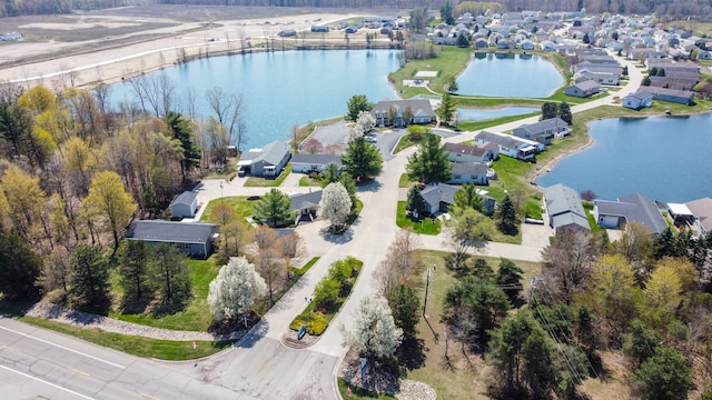 bird's eye view featuring a water view and a residential view