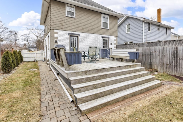 back of property featuring a fenced backyard and a wooden deck