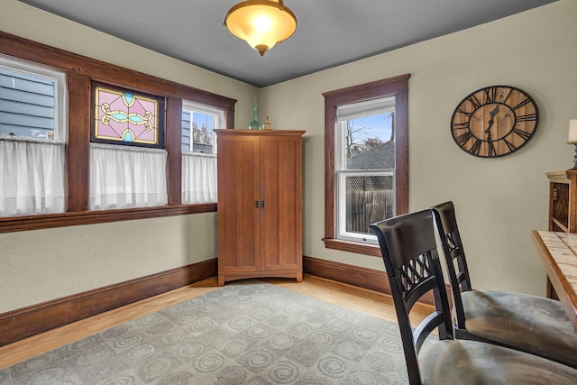 office area featuring light wood finished floors and baseboards