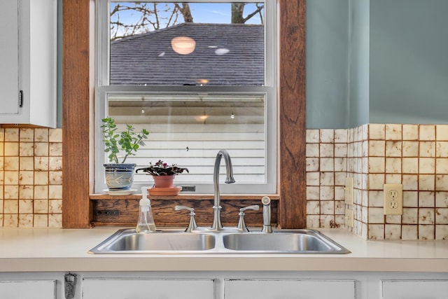 details featuring light countertops, white cabinets, and a sink