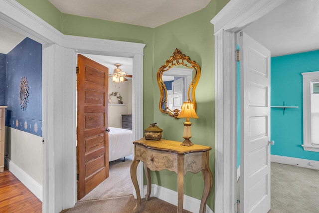 corridor featuring carpet flooring and baseboards