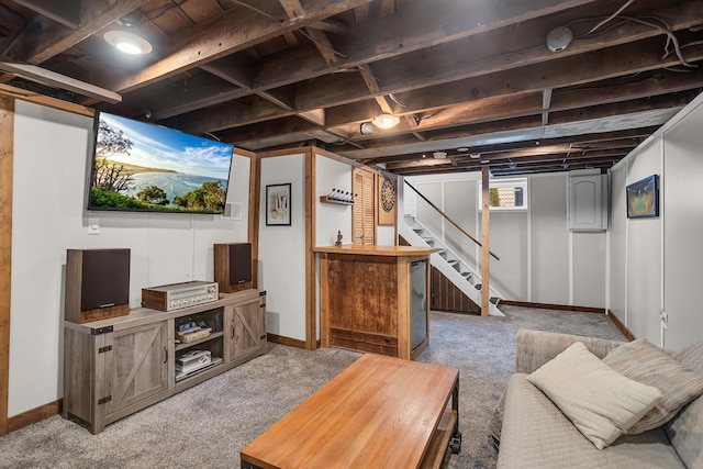 carpeted living area with baseboards and stairs