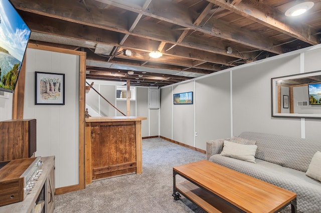 living area with baseboards and light carpet