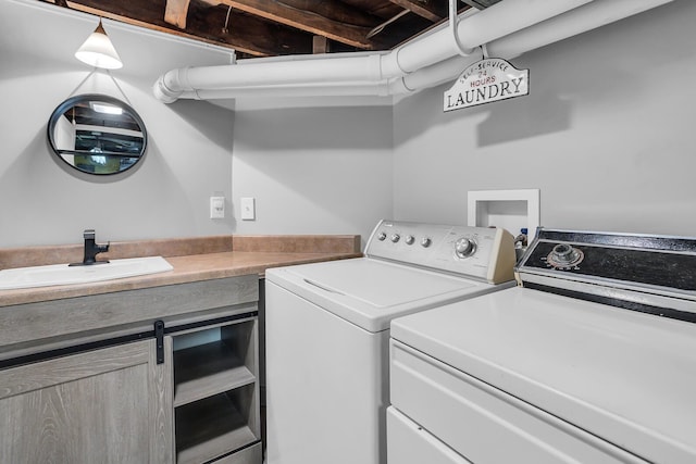 laundry area with a sink, laundry area, and washer and clothes dryer