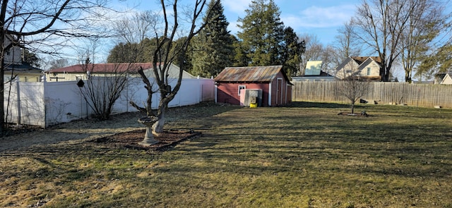 view of yard with a storage shed, a fenced backyard, and an outdoor structure