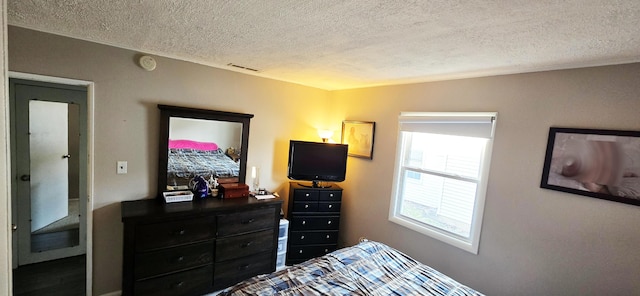 bedroom featuring visible vents and a textured ceiling