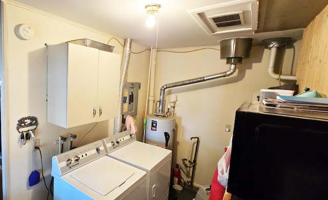 washroom featuring electric panel, cabinet space, visible vents, and washing machine and clothes dryer