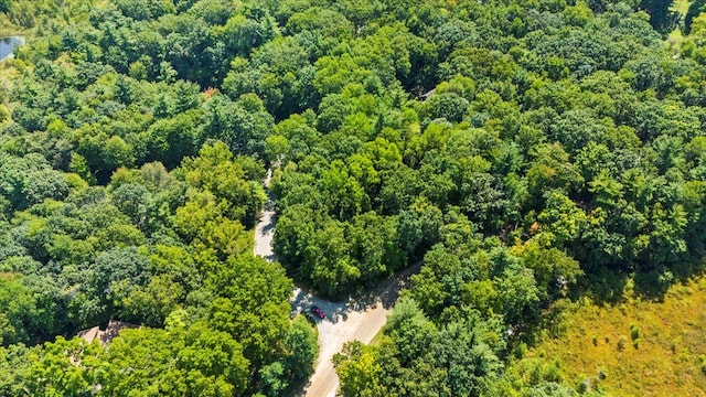 birds eye view of property with a wooded view