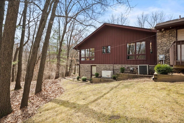 view of side of property with a yard and brick siding