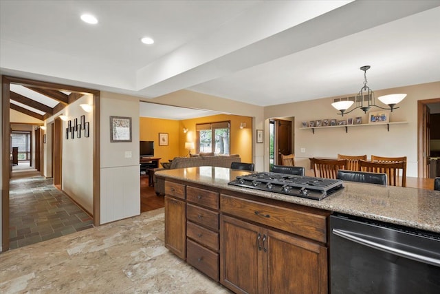 kitchen with open floor plan, recessed lighting, a notable chandelier, stone finish floor, and gas cooktop