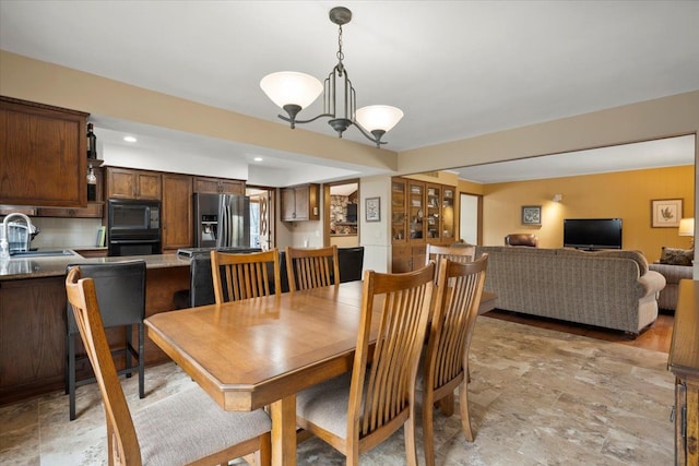 dining room with an inviting chandelier and recessed lighting