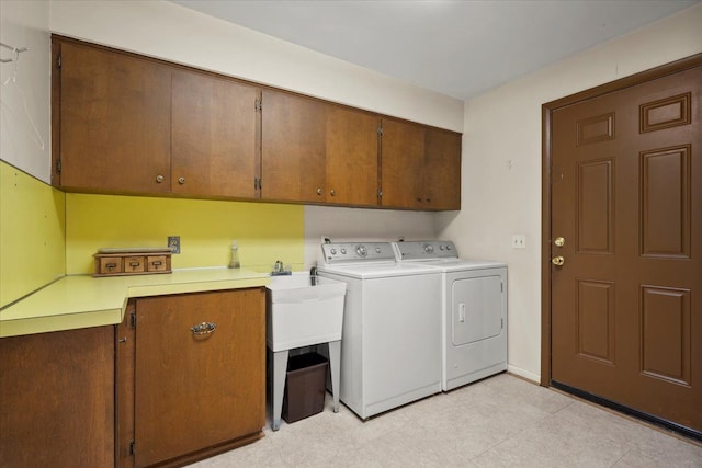 washroom featuring cabinet space and separate washer and dryer