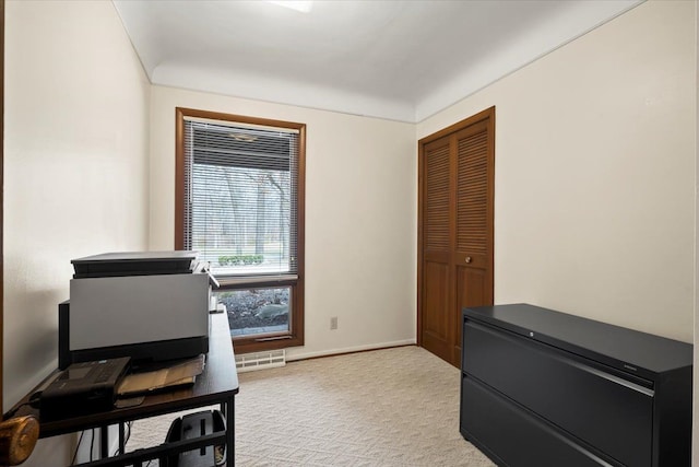 home office with light colored carpet, visible vents, and baseboards