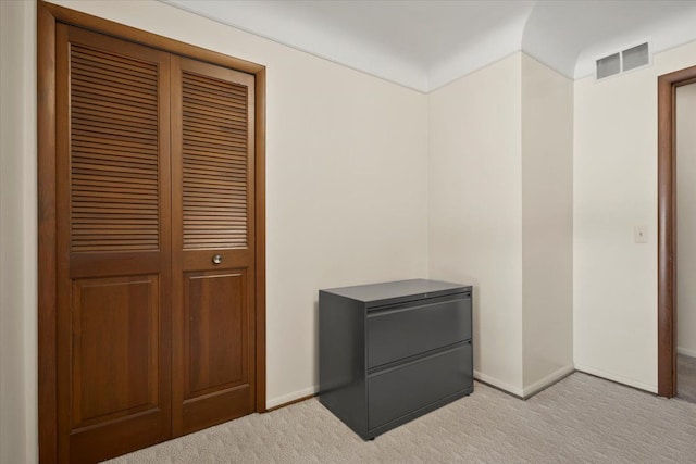 unfurnished bedroom featuring visible vents, light carpet, and baseboards