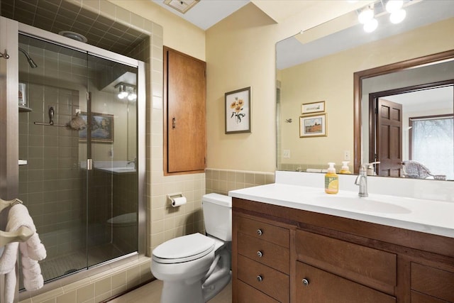 bathroom with visible vents, toilet, a stall shower, tile walls, and vanity