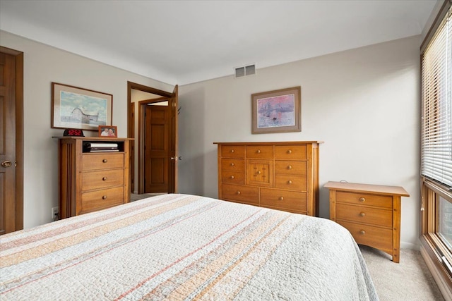 bedroom with visible vents and light colored carpet