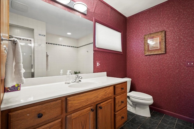 bathroom with vanity, baseboards, a stall shower, tile patterned flooring, and toilet