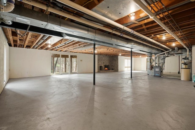 below grade area featuring heating unit and a fireplace