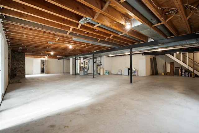 unfinished basement with heating unit and stairs