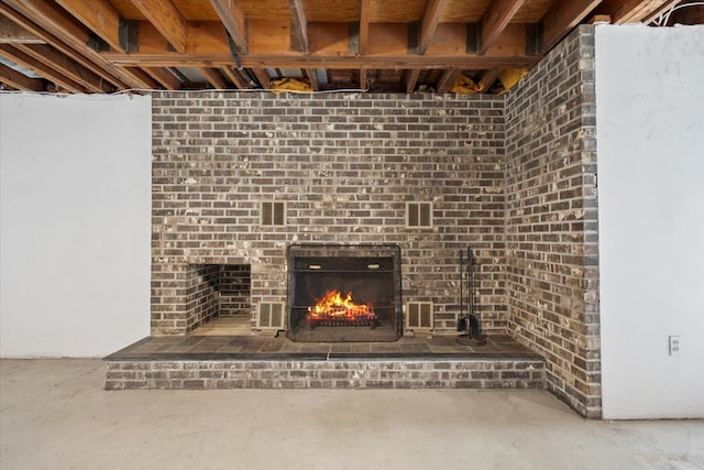 room details with a brick fireplace and concrete flooring