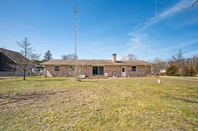 rear view of house featuring a yard, fence, brick siding, and a chimney