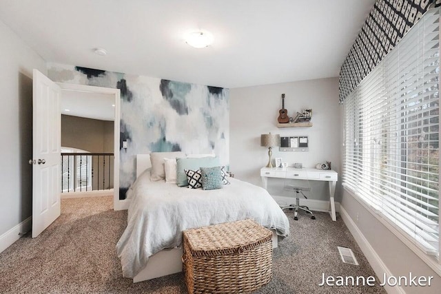 carpeted bedroom with visible vents and baseboards