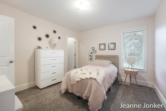 bedroom with baseboards and carpet floors