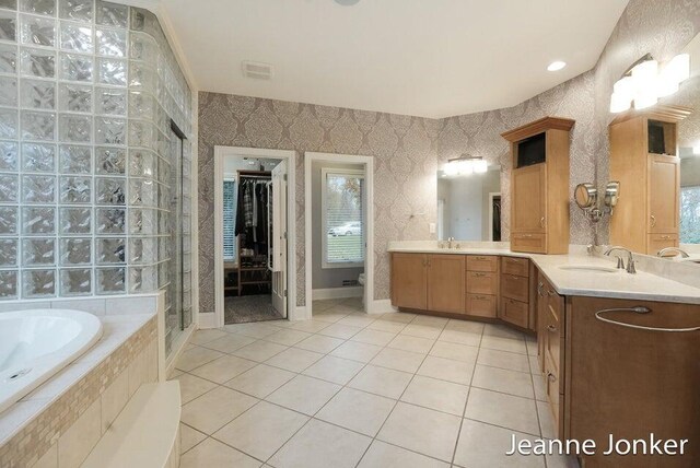 bathroom featuring vanity, wallpapered walls, tile patterned flooring, a shower stall, and a bath