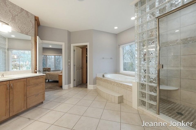 ensuite bathroom featuring a shower stall, connected bathroom, a garden tub, tile patterned floors, and vanity