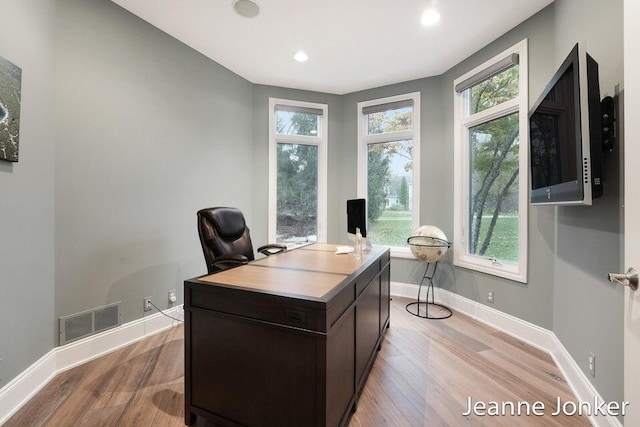 office with visible vents, baseboards, and light wood-style floors