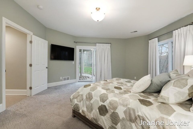 bedroom featuring access to outside, multiple windows, visible vents, and carpet floors