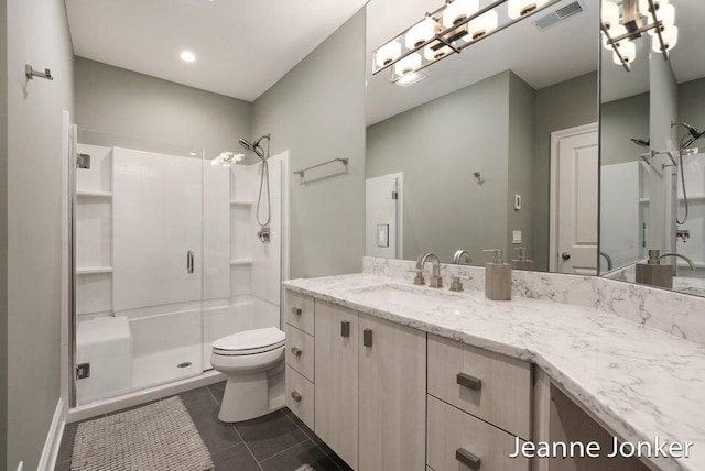 bathroom featuring visible vents, toilet, a shower stall, tile patterned flooring, and vanity