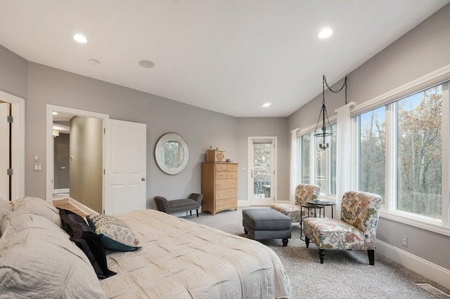 bedroom featuring visible vents, light colored carpet, baseboards, and multiple windows