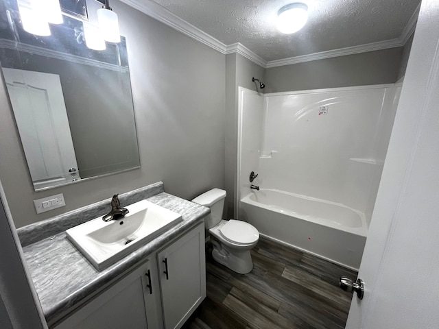 full bathroom featuring toilet, vanity, shower / bathing tub combination, wood finished floors, and a textured ceiling