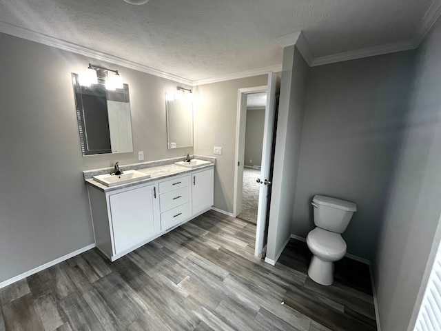 full bathroom featuring double vanity, wood finished floors, baseboards, and a sink